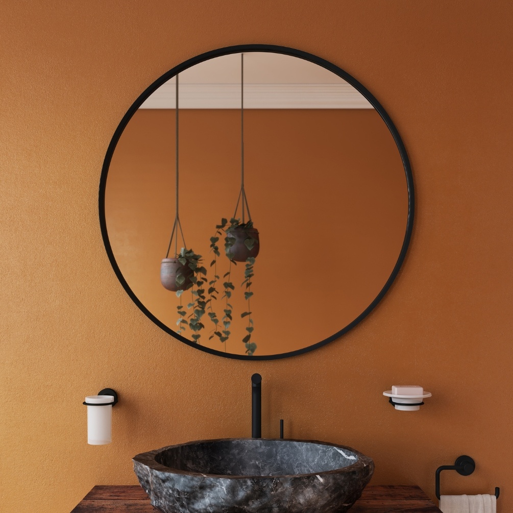 Lifestyle Image of the Origins Living Docklands 800mm x 800m Black Round Mirror mounted on an orange bathroom wall, in front of a modern style basin B375547